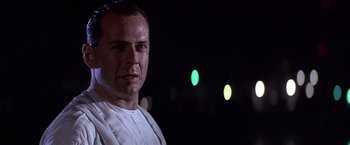 Movie still from “Sunset” (1988), directed by Blake Edwards – A person wearing a white shirt; Close Up shot, Low angle