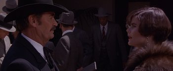 Movie still from “Sunset” (1988), directed by Blake Edwards – A group of men wearing suits and hats; Close Up shot, Over the shoulder angle