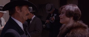 Movie still from “Sunset” (1988), directed by Blake Edwards – A group of men and women standing next to each other; Close Up shot, Over the shoulder angle