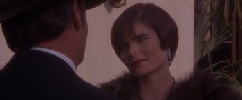 Movie still from “Sunset” (1988), directed by Blake Edwards – A man and a woman looking at one another in the mirror; Close Up shot, Over the shoulder angle