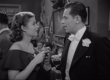 Movie still from “Sunset Blvd.” (1950), directed by Billy Wilder – A man and a woman are holding wine glasses; Medium shot, Over the shoulder angle