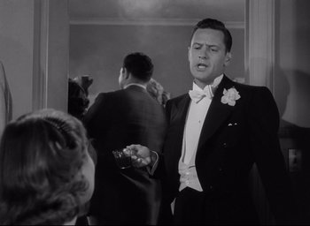 Movie still from “Sunset Blvd.” (1950), directed by Billy Wilder – A black and white photo of a man in a tuxedo; Medium shot, Low angle