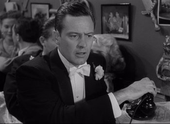Movie still from “Sunset Blvd.” (1950), directed by Billy Wilder – A black and white photo of a man in a tuxedo; Close Up shot, Low angle