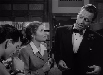 Movie still from “Sunset Blvd.” (1950), directed by Billy Wilder – Two women and a man in a suit and bow tie; Medium shot, Over the shoulder angle