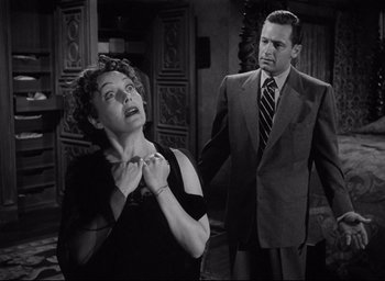 Movie still from “Sunset Blvd.” (1950), directed by Billy Wilder – An old photo of a man and a woman; Medium shot, Low angle