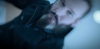 Movie still from “Altered Carbon” (2018), created by Laeta Kalogridis – A man with a beard is laying down; Extreme Close Up shot, Overhead angle