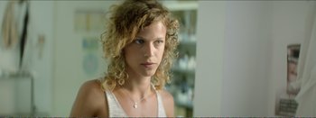 Movie still from “Suntan” (2016), directed by Argyris Papadimitropoulos – A person with curly hair; Close Up shot, Over the shoulder angle