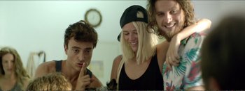 Movie still from “Suntan” (2016), directed by Argyris Papadimitropoulos – A group of young people standing next to each other; Close Up shot, Over the shoulder angle
