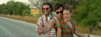 Movie still from “Suntan” (2016), directed by Argyris Papadimitropoulos – A group of people standing next to each other on the street; Medium shot, Over the shoulder angle