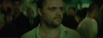 Movie still from “Suntan” (2016), directed by Argyris Papadimitropoulos – A person looking at the camera; Close Up shot, Over the shoulder angle