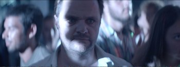 Movie still from “Suntan” (2016), directed by Argyris Papadimitropoulos – A person with a beard; Close Up shot, Over the shoulder angle