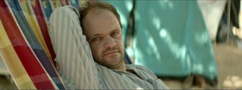Movie still from “Suntan” (2016), directed by Argyris Papadimitropoulos – A person laying in a chair; Close Up shot, Over the shoulder angle