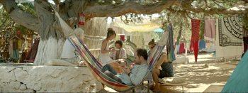 Movie still from “Suntan” (2016), directed by Argyris Papadimitropoulos – A group of people sitting in a hammock; Wide shot, High angle