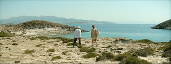 Movie still from “Suntan” (2016), directed by Argyris Papadimitropoulos – A man and a woman standing on a beach; Wide shot, High angle