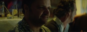 Movie still from “Suntan” (2016), directed by Argyris Papadimitropoulos – A person looking at the camera; Close Up shot, Over the shoulder angle