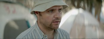 Movie still from “Suntan” (2016), directed by Argyris Papadimitropoulos – A person wearing a hat; Close Up shot, Over the shoulder angle