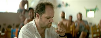Movie still from “Suntan” (2016), directed by Argyris Papadimitropoulos – A person holding a cigarette in his mouth; Close Up shot, Low angle