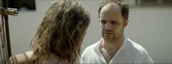 Movie still from “Suntan” (2016), directed by Argyris Papadimitropoulos – A man and a woman looking at each other in a mirror; Close Up shot, Over the shoulder angle