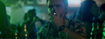 Movie still from “Suntan” (2016), directed by Argyris Papadimitropoulos – A man is smoking a cigarette in a bar; Close Up shot, Over the shoulder angle