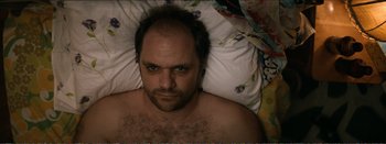 Movie still from “Suntan” (2016), directed by Argyris Papadimitropoulos – A person laying in a bed; Close Up shot, Overhead angle