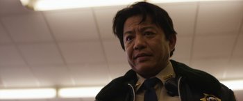 Movie still from “Super Dark Times” (2017), directed by Kevin Phillips – A person wearing a suit and tie; Close Up shot, Low angle