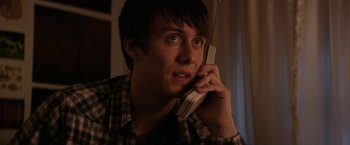 Movie still from “Super Dark Times” (2017), directed by Kevin Phillips – A man holding a phone up to his ear; Close Up shot, Low angle