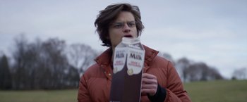 Movie still from “Super Dark Times” (2017), directed by Kevin Phillips – A person holding a milk carton in their hands; Close Up shot, Over the shoulder angle