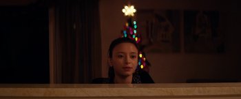 Movie still from “Super Dark Times” (2017), directed by Kevin Phillips – A woman is sitting in front of a christmas tree; Close Up shot, Low angle