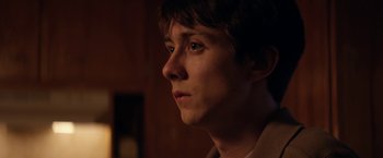 Movie still from “Super Dark Times” (2017), directed by Kevin Phillips – A young man is looking into the distance; Close Up shot, Over the shoulder angle