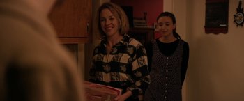 Movie still from “Super Dark Times” (2017), directed by Kevin Phillips – A woman holding a box in her hands; Medium shot, Over the shoulder angle