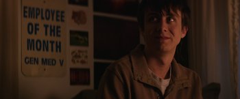 Movie still from “Super Dark Times” (2017), directed by Kevin Phillips – A young man is smiling for the camera; Close Up shot, Over the shoulder angle