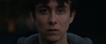 Movie still from “Super Dark Times” (2017), directed by Kevin Phillips – A young man's face in the dark; Close Up shot, Over the shoulder angle