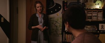 Movie still from “Super Dark Times” (2017), directed by Kevin Phillips – A woman standing in front of a mirror talking to another woman; Medium shot, Over the shoulder angle