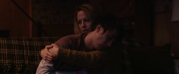 Movie still from “Super Dark Times” (2017), directed by Kevin Phillips – A man and a woman snuggling on a couch; Close Up shot, Low angle
