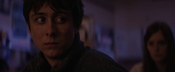 Movie still from “Super Dark Times” (2017), directed by Kevin Phillips – A man's face in a dark room; Close Up shot, Over the shoulder angle