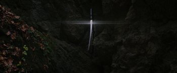 Movie still from “Super Dark Times” (2017), directed by Kevin Phillips – A sword is lit up in the dark by the light; Extreme Wide shot, Overhead angle