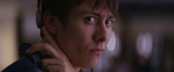Movie still from “Super Dark Times” (2017), directed by Kevin Phillips – A person's face with blurry lights in the background; Close Up shot, Low angle