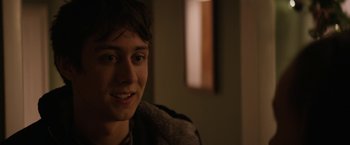 Movie still from “Super Dark Times” (2017), directed by Kevin Phillips – A person smiling at the camera; Close Up shot, Over the shoulder angle
