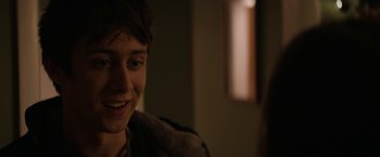 Movie still from “Super Dark Times” (2017), directed by Kevin Phillips – A person smiling at the camera; Close Up shot, Over the shoulder angle