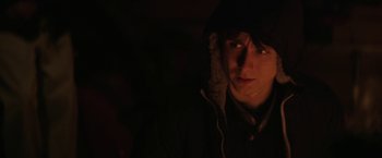 Movie still from “Super Dark Times” (2017), directed by Kevin Phillips – A man in a black jacket and a hood; Close Up shot, Over the shoulder angle