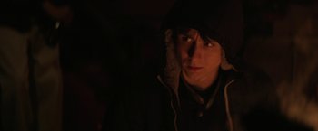 Movie still from “Super Dark Times” (2017), directed by Kevin Phillips – A person with a hood is looking at the camera; Close Up shot, Over the shoulder angle