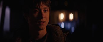 Movie still from “Super Dark Times” (2017), directed by Kevin Phillips – A young man is sitting in a dark room; Close Up shot, Over the shoulder angle