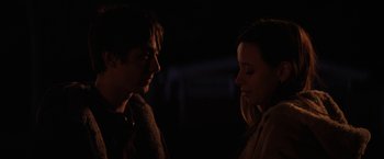 Movie still from “Super Dark Times” (2017), directed by Kevin Phillips – A man and a woman standing next to each other in the dark; Close Up shot, Over the shoulder angle