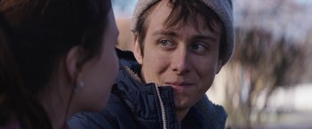 Movie still from “Super Dark Times” (2017), directed by Kevin Phillips – A person wearing a jacket and a hat; Close Up shot, Over the shoulder angle