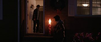 Movie still from “Super Dark Times” (2017), directed by Kevin Phillips – A person standing in front of a lit candle; Wide shot, Over the shoulder angle