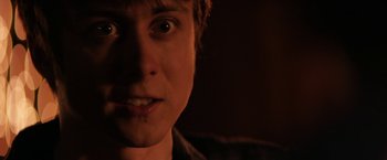 Movie still from “Super Dark Times” (2017), directed by Kevin Phillips – A person's face in a dark room; Close Up shot, Over the shoulder angle
