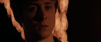 Movie still from “Super Dark Times” (2017), directed by Kevin Phillips – A young man is looking into the camera; Close Up shot, Over the shoulder angle