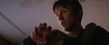 Movie still from “Super Dark Times” (2017), directed by Kevin Phillips – A young man holding something in his hands; Close Up shot, Low angle