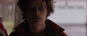 Movie still from “Super Dark Times” (2017), directed by Kevin Phillips – A man with glasses is looking at the camera; Close Up shot, Low angle
