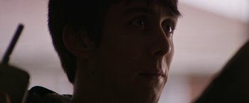 Movie still from “Super Dark Times” (2017), directed by Kevin Phillips – A young man's face in the dark; Close Up shot, Low angle
